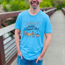 Load image into Gallery viewer, Man wearing a blue unisex t-shirt with ‘Let’s All Go to the Supper Club’ black-and-white text and cartoon characters of a brandy old fashioned, golden dinner roll, relish tray, and blueberry cheesecake.