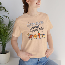 Load image into Gallery viewer, Woman wearing a cream unisex t-shirt with ‘Let’s All Go to the Supper Club’ black-and-white text and cartoon characters of a brandy old fashioned, golden dinner roll, relish tray, and blueberry cheesecake.